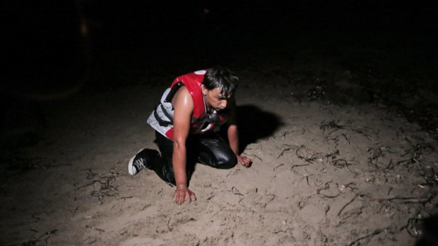 A migrant catches his breath on the beach at Bodrum, Turkey after a failed attempt to cross on a dinghy to the Greek island of Kos.