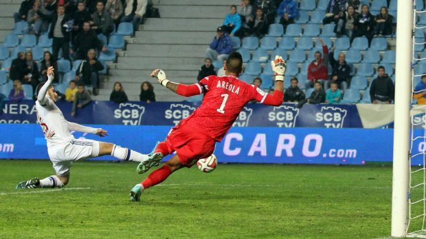 Bastia's keeper Alphonse Areola vies with Lyon's forward Yassine Benzia.