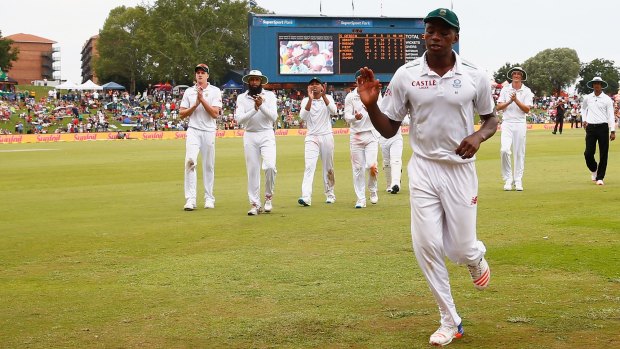 Kagiso Rabada leads South Africa off the pitch at the end of England's first innings.
