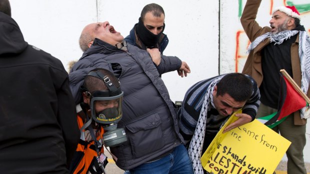 AP cameraman Eyad Hamad is evacuated after being hit by tear gas during clashes between Palestinian protesters and Israeli border police officers in Bethlehem on Friday.