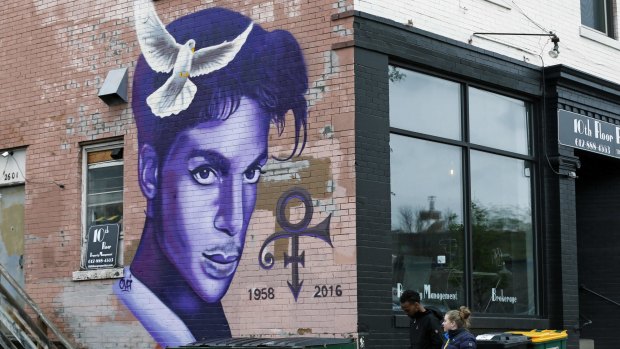 A mural honoring the late rock star Prince adorns a building in the Uptown area of Minneapolis Thursday, April 28, 2016, Prince died last week at his Paisley Park home at the age of 57. An investigation into his death continues. (AP Photo/Jim Mone)