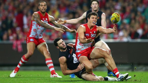 Kurt Tippett of the Swans is tackled during the match against Carlton. Wayne Carey believes the forward could be used as trade bait by Sydney.
