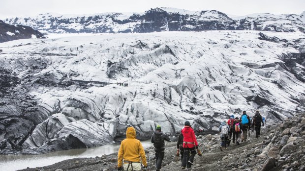 Hikers head towards the Solheimajokull Glacier.