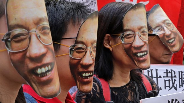 Protesters wear masks of Chinese Nobel Peace laureate Liu Xiaobo during a demonstration demanding his release outside the Chinese liaison office in Hong Kong in June 2017.