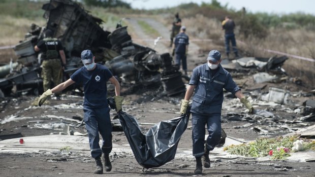 Emergency workers recover victims from the crash site of Malaysia Airlines flight MH-17 in Ukraine in July last year.
