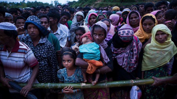 Rohingya Muslims recently arrived from Myanmar queue for food at a refugee camp in Cox's Bazar, Bangladesh, as Aung Sun Suu Kyi made her speech on Tuesday.