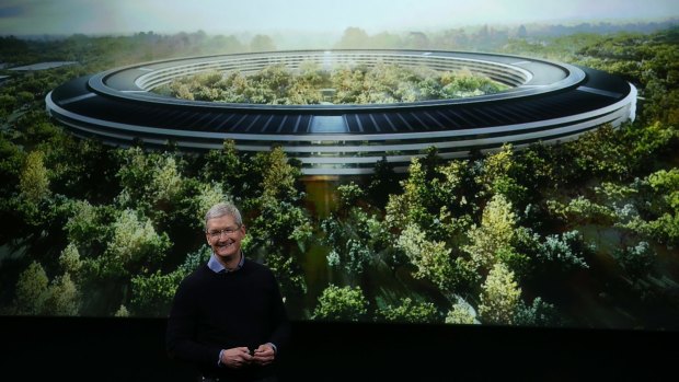 Apple CEO Tim Cook in front of an artist's impression of the new campus, Apple Park. 