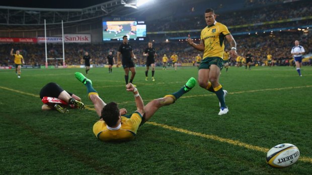 Great fist of it: Adam Ashley-Cooper celebrates his try with Israel Folau.