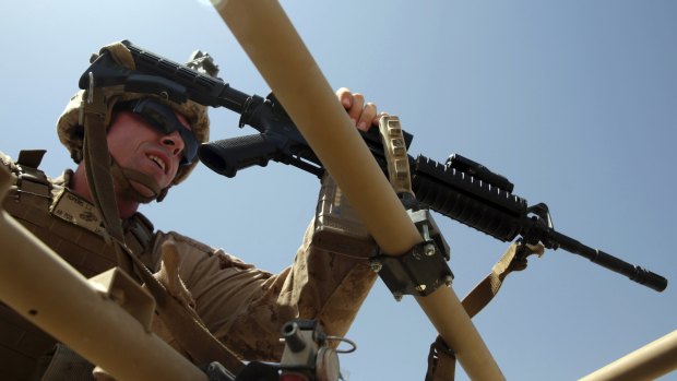 A US Marine prepares for a training session for Afghan army commandos in Helmand province, Afghanistan