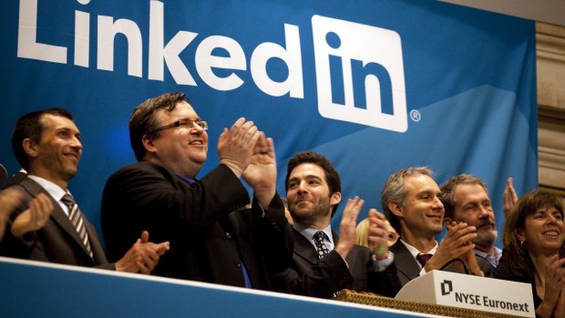 Reid Hoffman, chairman and co-founder of LinkedIn, left, and chief executive Jeff Weiner, centre, applaud during the opening bell ceremony at the New York Stock Exchange as LinkedIn listed in 2011.  Microsoft announced this week that it's buying LinkedIn for a whopping $US26.2 billion ($35.5 billion).