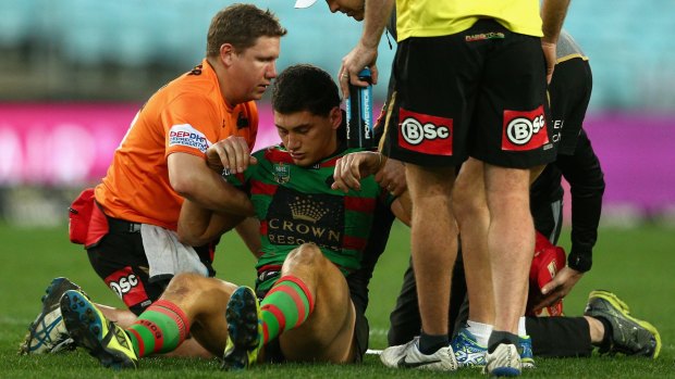 Dazed and confused: Souths forward Kyle Turner is assisted from the field during the clash with the Penrith Panthers at ANZ Stadium.