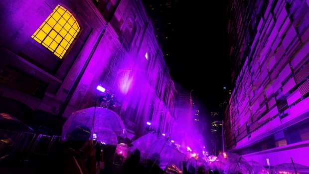 Melburnians enjoy the Purple Rain installation.