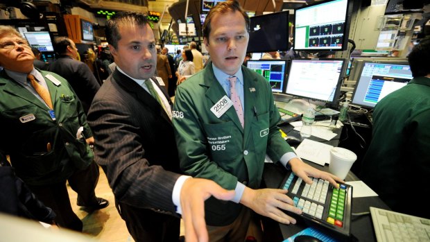 William Brazer, right, of Lehman Brothers MarketMakers, and Anthony Campagna of Speer, Leeds, Kellogg work on the floor of the New York Stock Exchange, Friday, September 19, 2008, in New York. 