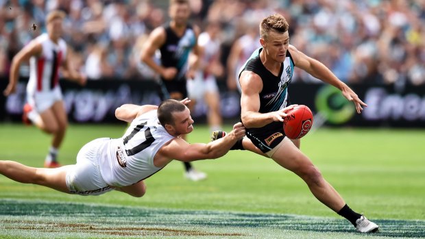 Fleet-footed: Robbie Gray evades a tackle from St Kilda's Dylan Roberton.