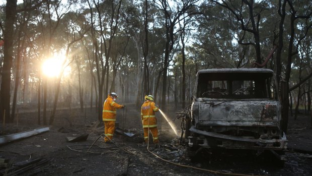 Rural fire crews attend to the burnt out wreck of what might have have been the source of the fires near Londonderry.