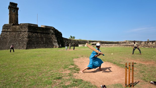 Boys playing cricket. Galle Fort.