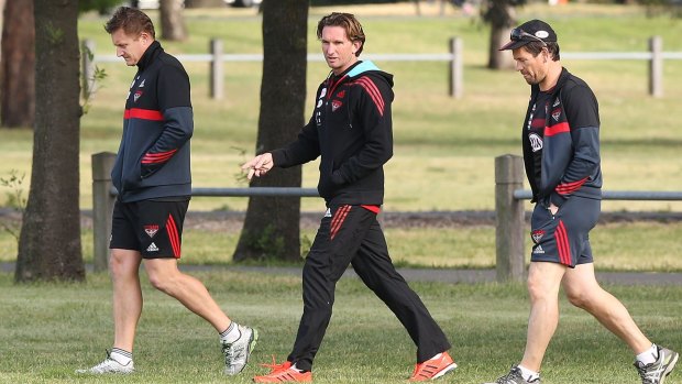 James Hird (centre) and his newly appointed assistant coaches Mark Neeld (left) and Mark Harvey walk off after a time trial during an Essendon training session at Visy Park on November 6.