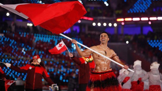Oiled torso: Australian-born Pita Taufatofua carries the flag of Tonga during the opening ceremony of the 2018 Winter Olympics in PyeongChang, South Korea.