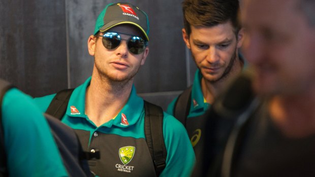 Australian cricket captain Steve Smith, left, arrives with teammates, at the Cape Town International airport to depart to Johannesburg for the final five day cricket test match, in Cape Town, South Africa, Tuesday, March 27, 2018. Smith has been suspended by the International Cricket Council for the match for his part in a ball tampering scandal during the third test. Smith admitted some senior players were aware of the tampering attempt. (AP Photo/Halden Krog)