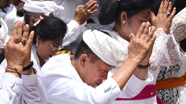 Balinese Governor I Made Mangku Pastika prays at the full moon ceremony at the Besakih Mother Temple.