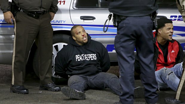 Men under arrest after the confrontation at the gas station in Berkeley, Missouri.