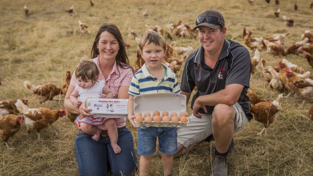 Free-range egg farmers Theresa and Craig Robinson, with two of their children, Alya, seven months, and William, three years old.