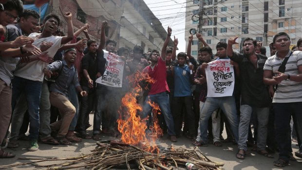 Bangladeshi students protest seeking the arrest of three motorcycle-riding assailants who hacked student activist Nazimuddin Samad to death.