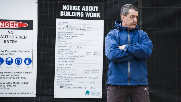 Leo Carvalho of Lyons is concerned about unsafe Mr Fluffy demolitions and protested outside his neighbour's home on Thursday morning.