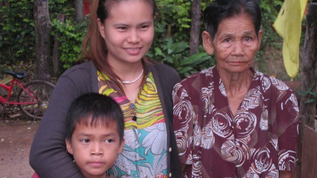 Eleven-year-old Satunom "Nom" Apipat, left, with his mother Salakjit "Ying" Apipat (centre) and grandmother Phey Sihawong. Ying says she gave birth to Nom after being raped by rogue monk Wirapol Sukphol.