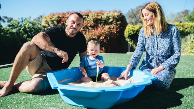 Josh Hodgson at home with his wife Kirby and son George.