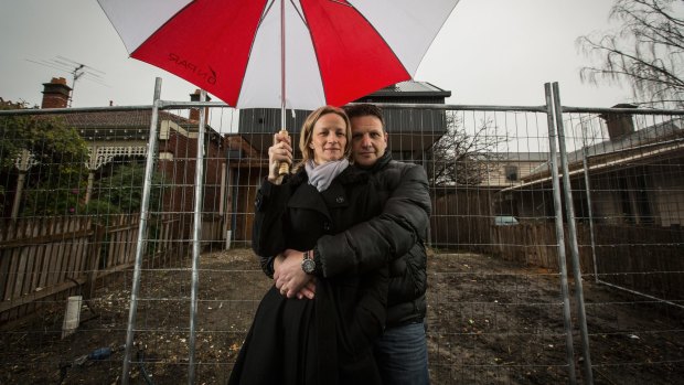 Alison and Mark Attard outside their fenced off Clifton Hill home  in Melbourne. 