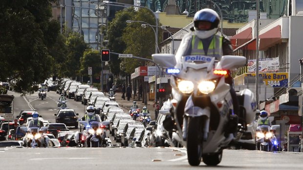 Thirty three hearses carrying Australian service personnel and their dependents drive through Parramata streets after its repatriation.