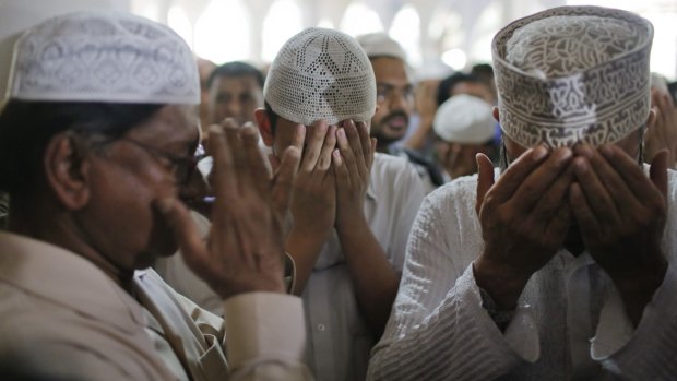 Father (left) and son (centre) of Faisal Arefin Deepan, a publisher of secular books, pray at his funeral in Dhaka, Bangladesh, last Sunday. 