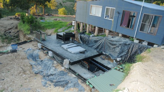 A trapdoor led to three buried shipping containers where a large hydroponic cannabis set up was allegedly discovered.
