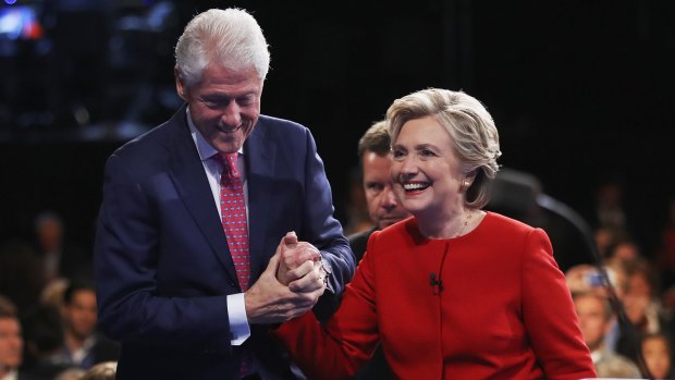 Hillary Clinton shakes hands with husband Bill Clinton after the Presidential Debate with Republican presidential nominee Donald Trump at Hofstra University on September 26, 2016 in Hempstead, New York.