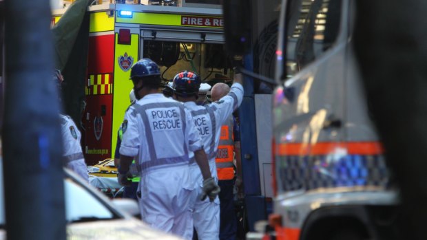 Emergency services work to free Christine Mulholland, who died after being hit by a bus on Clarence Street.