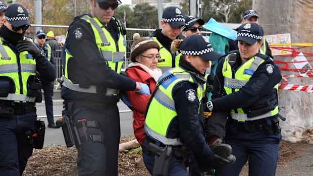 Police move in on the protesters at Flemington road. 