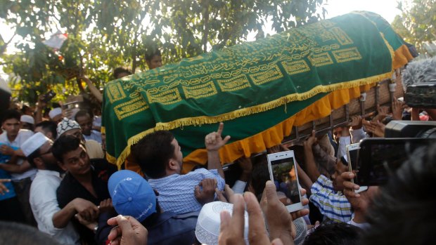 People carry the coffin of  Ko Ni to his final resting place.