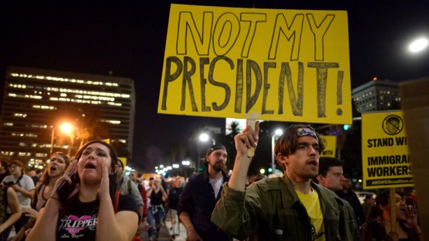 Protesters shout and brandish signs in Los Angeles.