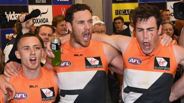 Victorious: Tom Scully, Shane Mumford and Jeremy Cameron sing the song with gusto.