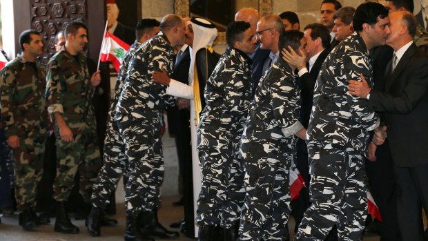 The released men are kissed by Lebanese and Qatari officials upon their arrival in Beirut.