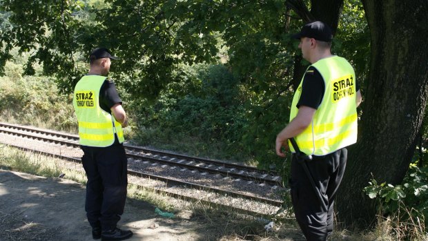 Railway guards patrol tracks to prevent gold hunters from getting harmed by passing trains near the site where two men allegedly found a Nazi gold train hidden underground near Walbrzych, Poland, on Monday.