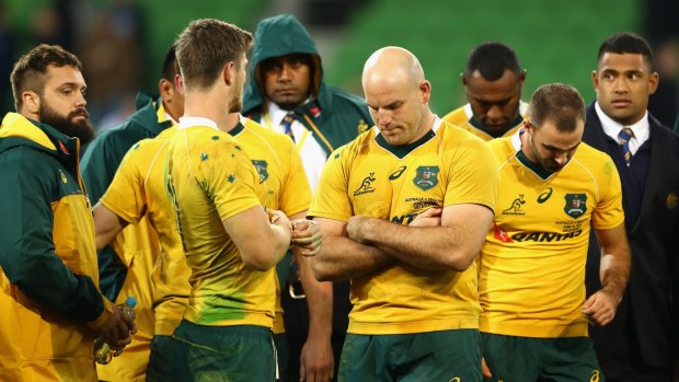 Downcast: Wallabies captain Stephen Moore and teammates look dejected after losing the series in Melbourne.