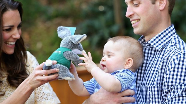 Prince William holds Prince George as his mother Catherine hands him a toy bilby during their visit to Australia last year.