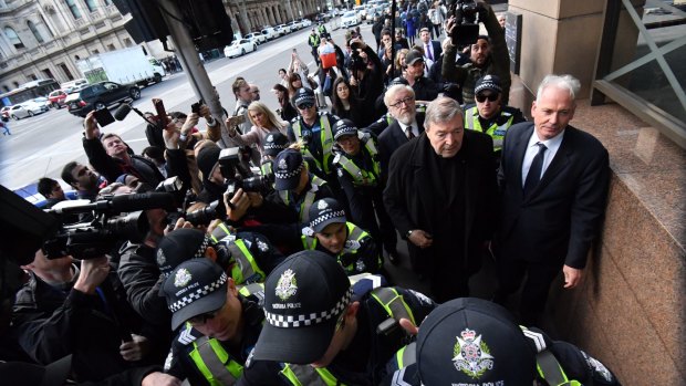 The Cardinal arrives at Melbourne Magistrates Court with his lawyers Paul Galbally (right) and Robert Richter, QC.