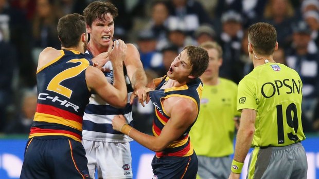 Cop that: The Crows' Matt Crouch reacts as brother Brad and 200-game Cat Tom Hawkins wrestle at Simonds Stadium on Friday night.