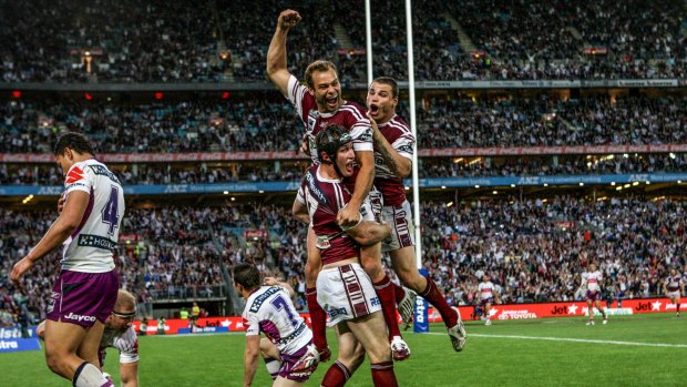 Grand finale: Steve Menzies (headgear) celebrates with Brett Stewart and Anthony Watmough after scoring a try in his final game for Manly in the 2008 NRL grand final.