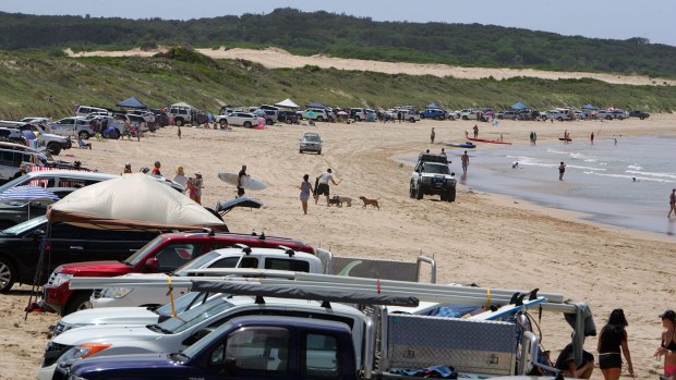 Vehicles line up along the dunes after paying a $30 fee. 