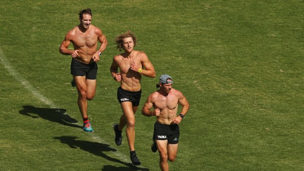 Running back: Travis Colyer leads fellow banned Bombers Dyson Heppell (centre) and Jobe Watson during a training session.