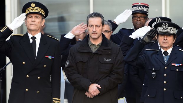 French police officer Philippe Brinsolaro (centre), brother of slain police officer Franck Brinsolaro, observes a minute of silence  in Marseille for the victims of the attack.